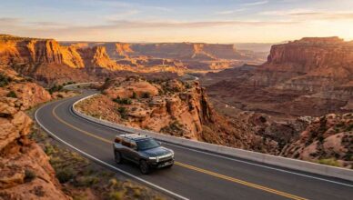 A modern SUV on Utah Scenic Byway 12 at golden hour with red rock cliffs and layered canyon country