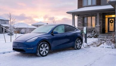 photorealistic image of a 2026 Tesla Model Y Long Range parked in a snowy suburban driveway at early morning