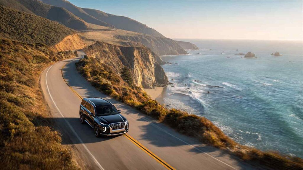  2026 Hyundai Palisade Calligraphy driving on a coastal highway with ocean view