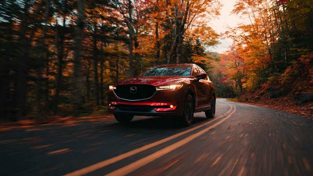  Mazda CX-5 on a winding country road in autumn foliage, driver's perspective