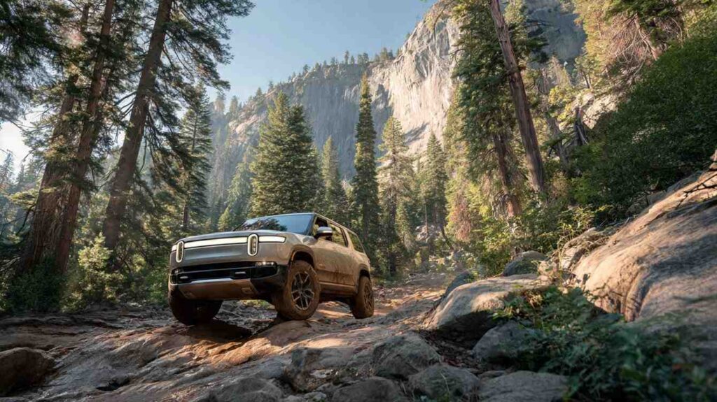 2026 Rivian R1S on a rocky mountain trail with forest backdrop