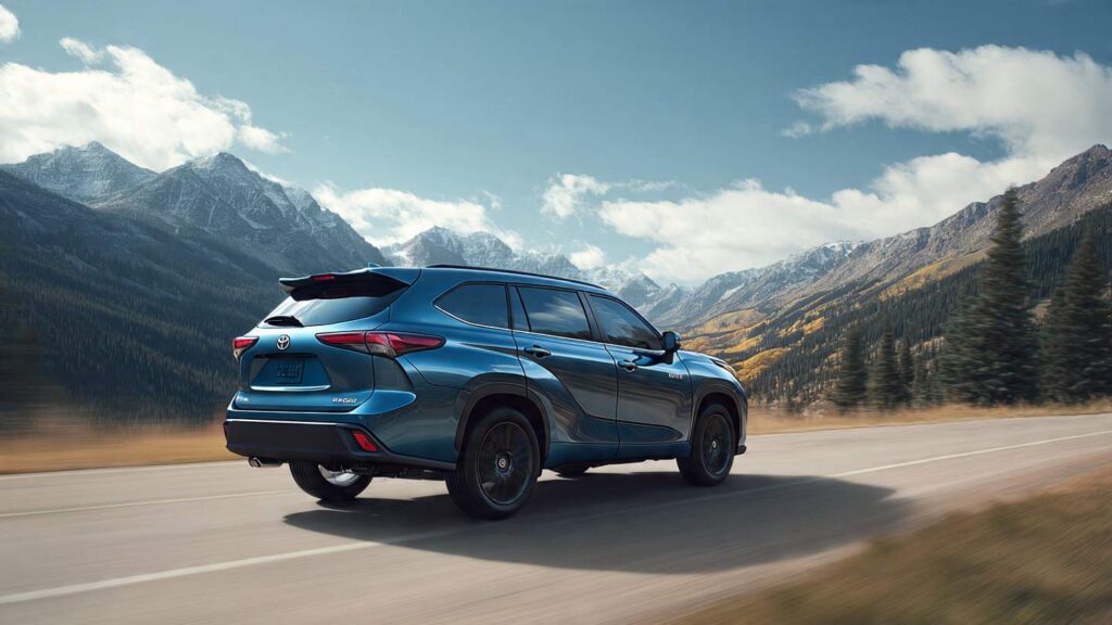 Toyota Highlander Hybrid on a highway with mountains in background
